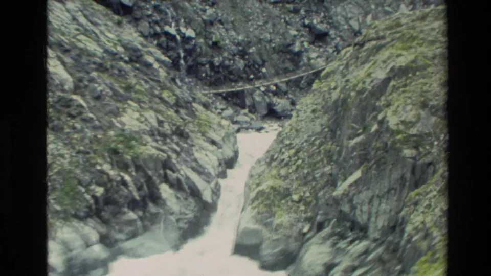 1982 New Zealand 8mm frame of rushing white water cutting through a narrow rocky mountain gorge.
