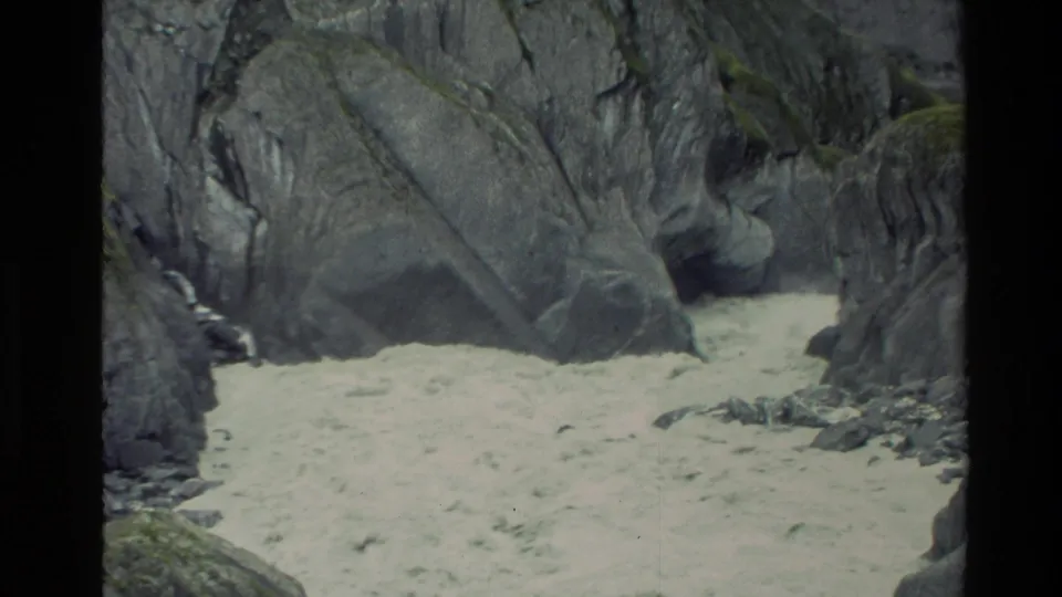 1982 New Zealand 8mm frame of muddy rapid water running between close rock walls in a narrow canyon.