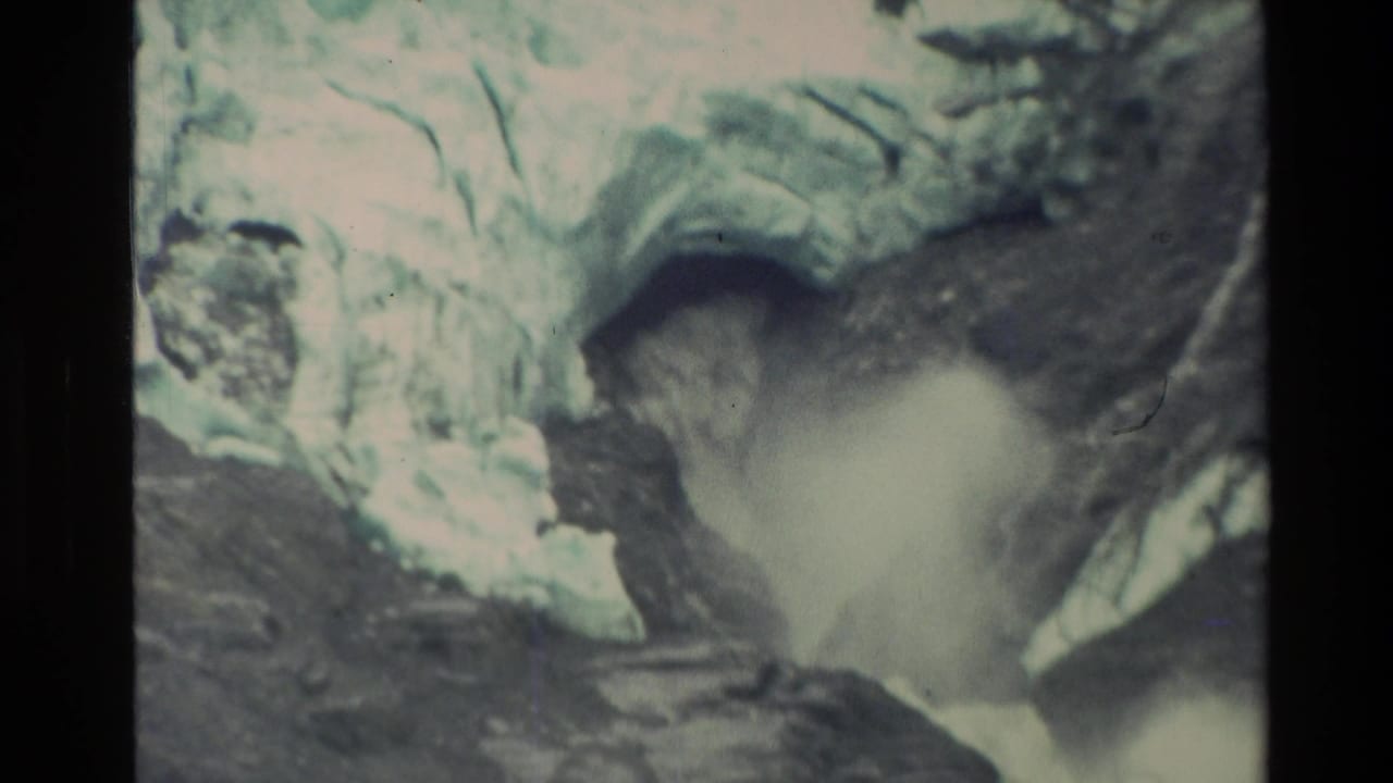 1982 New Zealand 8mm frame showing turbulent milky water pushing through a narrow rocky mountain channel.