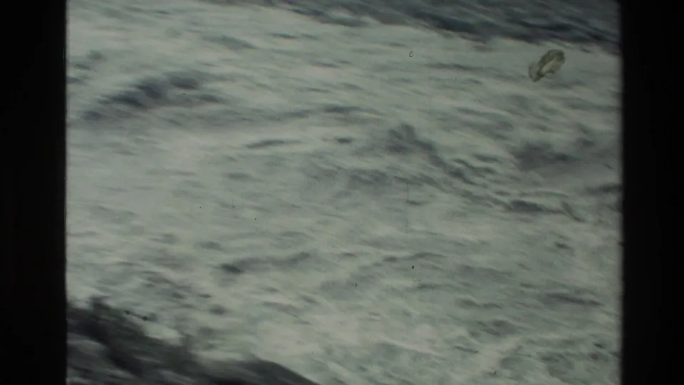 1982 New Zealand 8mm frame showing a close, abstract view of rushing water and surface ripples.