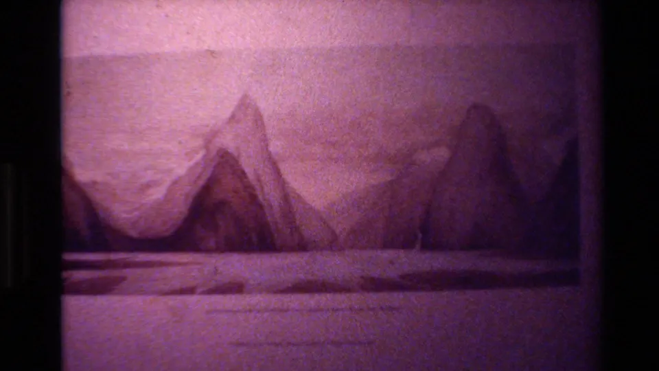Faded 8mm frame from the 1982 New Zealand lake sequence, showing a magenta-toned mountain and water view with heavy film texture.