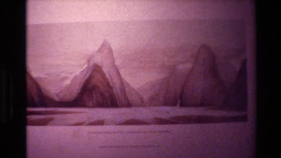1982 New Zealand 8mm still of a mountain illustration, slightly tilted in frame with pink-purple fading, soft focus, and black side borders.