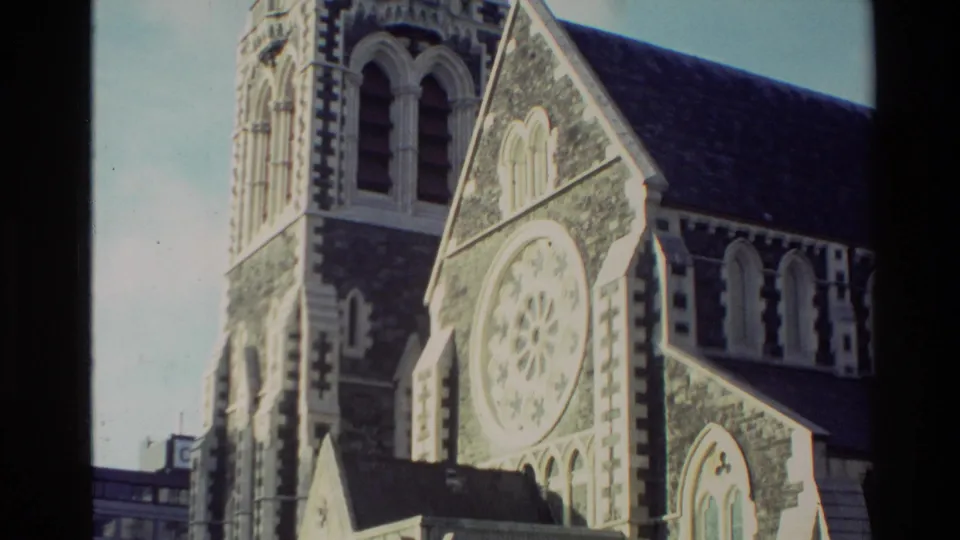 1982 New Zealand 8mm frame showing an angled exterior view of the cathedral tower, rose window and patterned stonework.