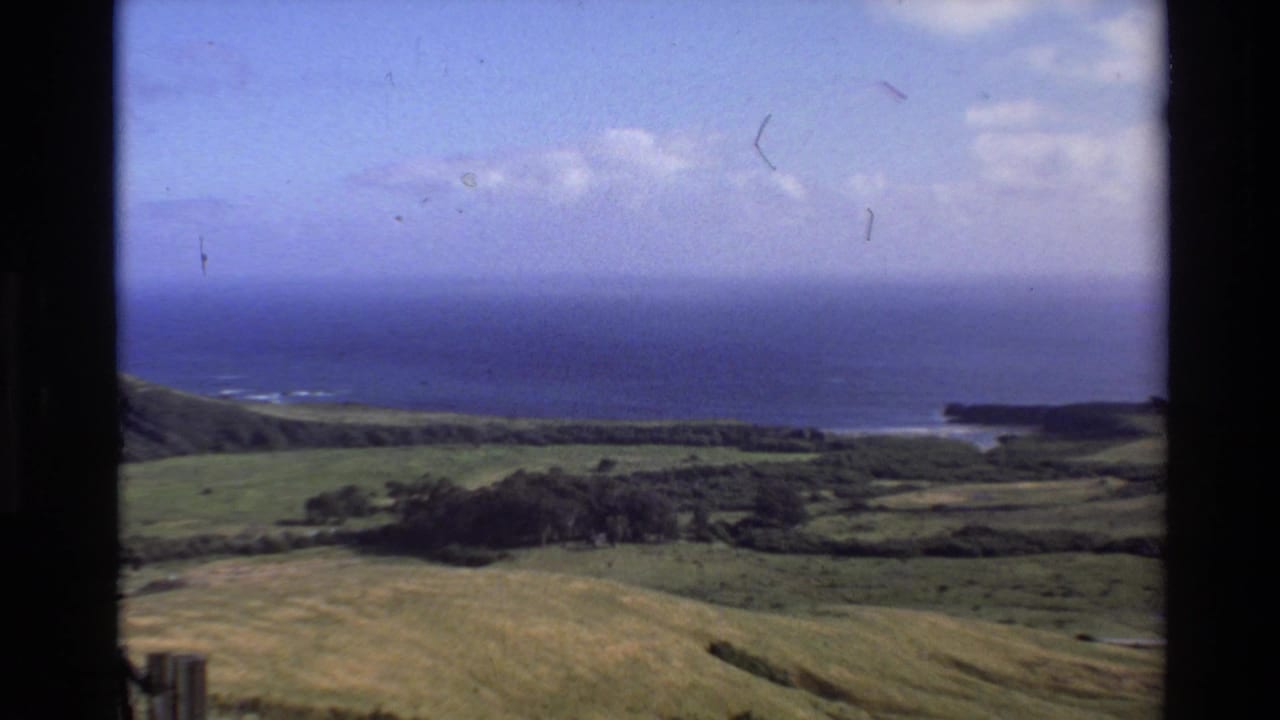 Coastal hills and blue ocean seen from an elevated viewpoint.