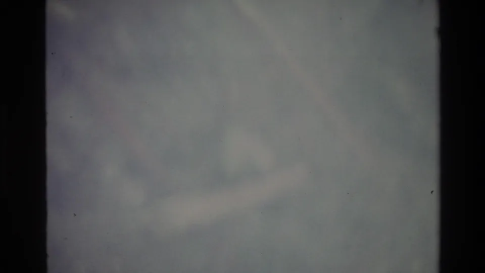 8mm abstract frame of pale bluish-grey haze — possibly overcast sky or coastal fog — with no discernible subject, Big Sur area, circa 1980.