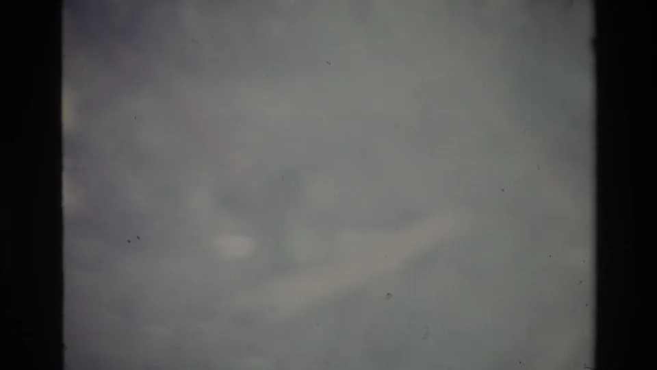 8mm abstract frame of grey-blue haze nearly identical to previous frame, suggesting camera held on an undifferentiated pale subject, Big Sur area, circa 1980.