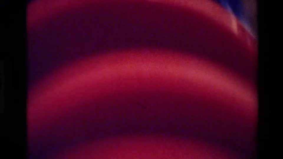 Big Sur 1980 8mm frame with the red plate rim close to the lens and the checked cloth receding in soft focus.