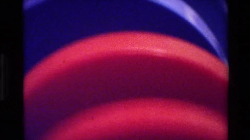 Soft 8mm close-up from Big Sur in 1980 showing a red plate rim and blue-toned table setting detail.