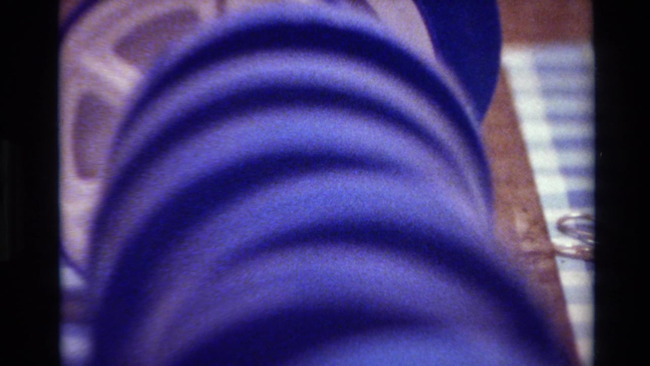 A blue film spool appears in close-up, likely 8mm home-movie material from the Big Sur 1980 reel metadata.