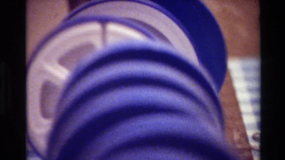 The closing frame shows the blue reel and pale spool center in a grainy 1980 Big Sur home-movie scan.