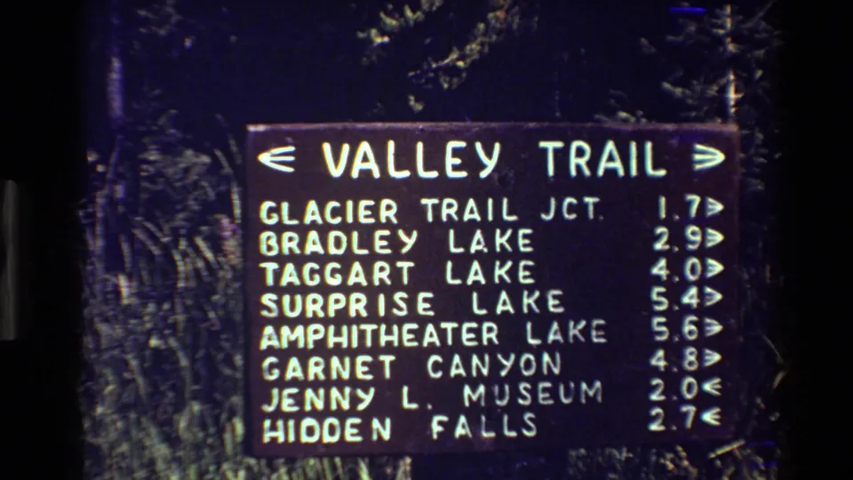 Grand Teton Valley Trail distance board listing Glacier Trail junction, Bradley Lake, Taggart Lake, Surprise Lake, and other destinations.