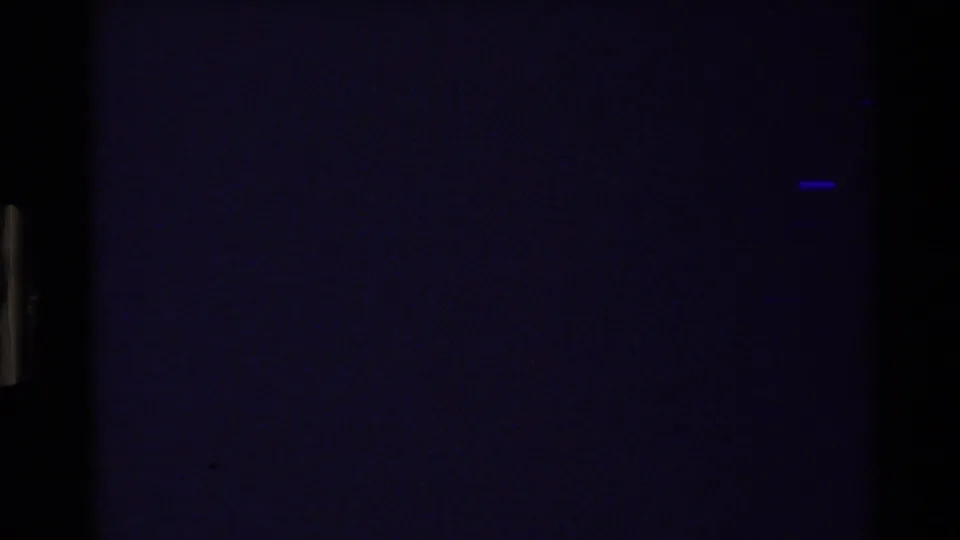 Dark opening frame from the 1980 Grand Teton home movie, with little landscape detail visible and strong film grain.
