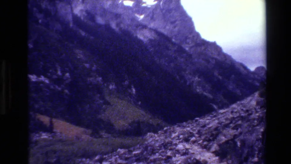 The final frame shifts to a rocky Grand Teton mountain slope and valley terrain under pale sky.