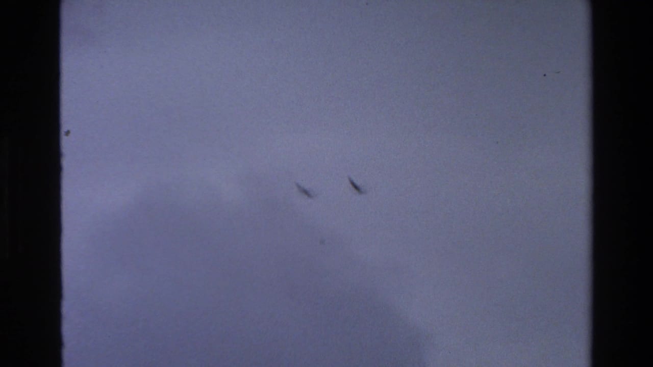 Bird silhouettes remain visible in the cloudy sky during the 1980 Grand Teton 8mm sequence.