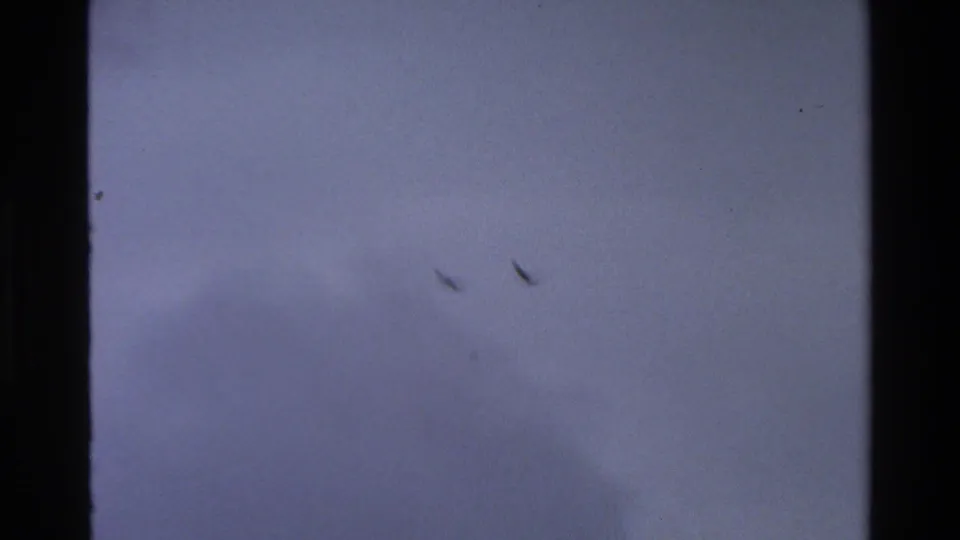 Bird silhouettes remain visible in the cloudy sky during the 1980 Grand Teton 8mm sequence.