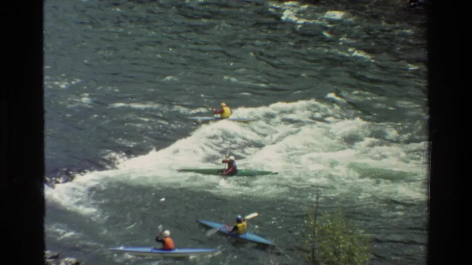 The final frame shows multiple kayakers around a whitewater feature in Grand Teton river footage, viewed from a distant elevated angle.