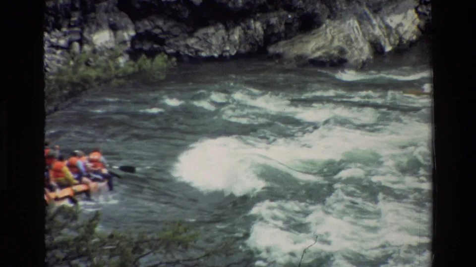 The raft group is partly visible at frame left as whitewater rolls across the Grand Teton river scene in this 1980 home-movie shot.