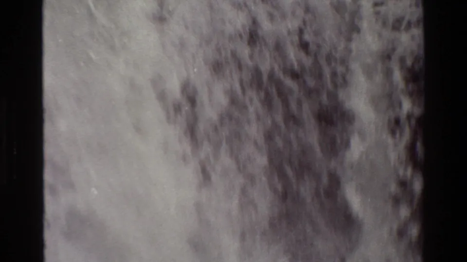1980 Grand Teton 8mm footage shows a broad waterfall and dark rock ledges, softened by grain and exposure shift.