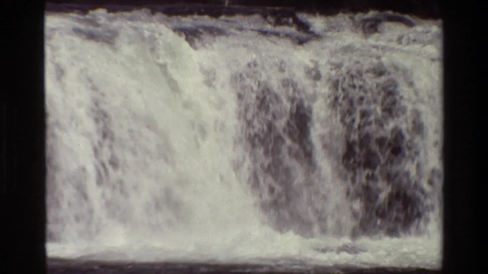 1980 Grand Teton 8mm frame shows the lower waterfall meeting a dark river surface beneath foaming white water.