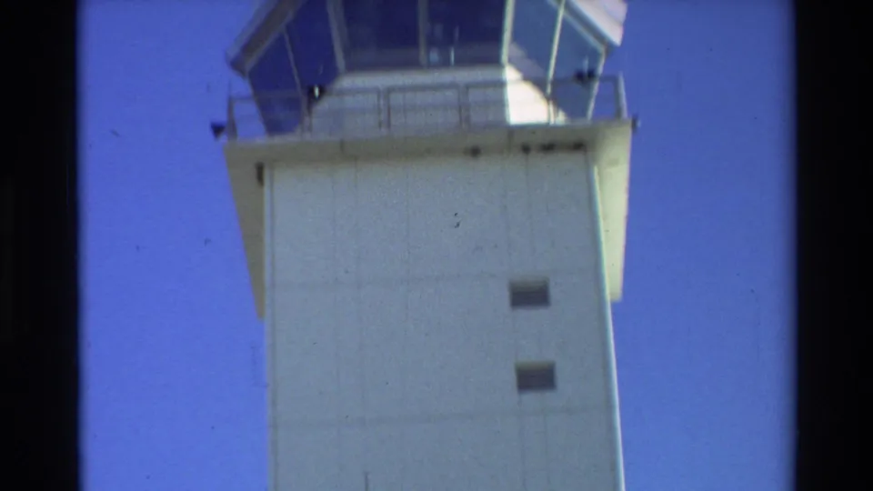 1981 Beale AFB frame showing the tall air traffic control tower and windowed cab against a clear blue sky.