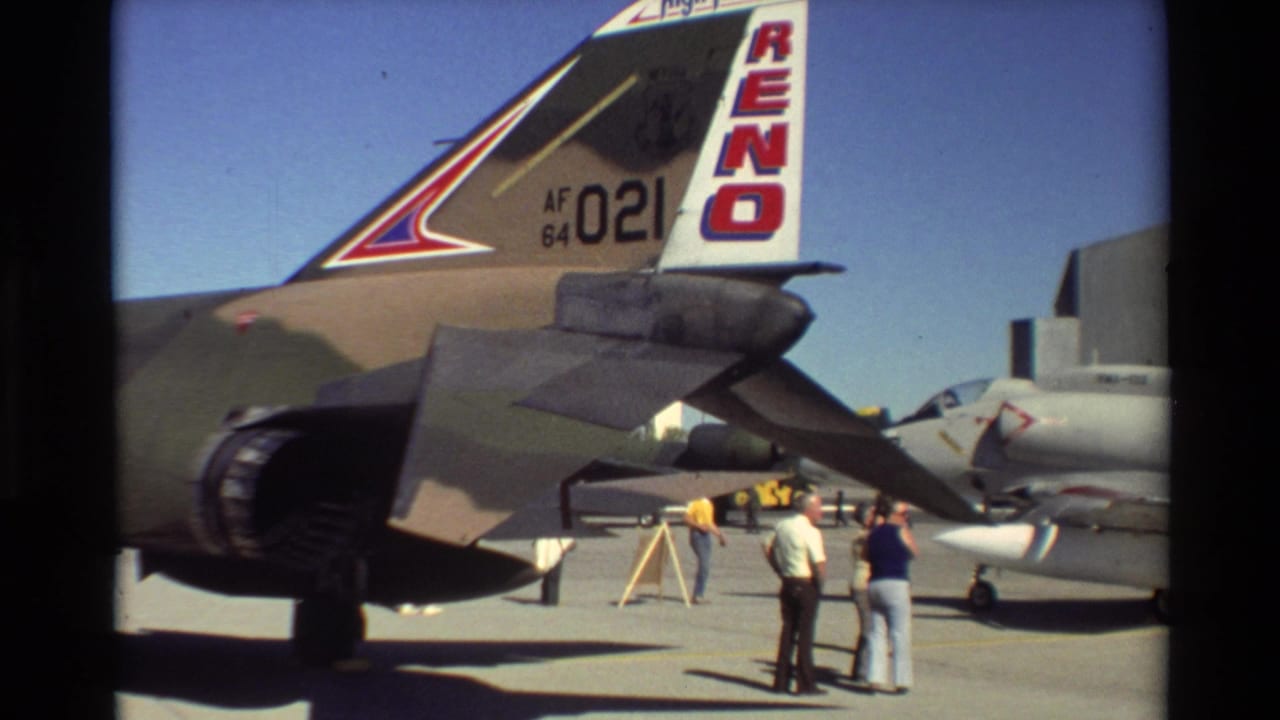 1981 Beale AFB home-movie frame showing the rear of an F-4 Phantom II with RENO tail markings and civilians nearby.