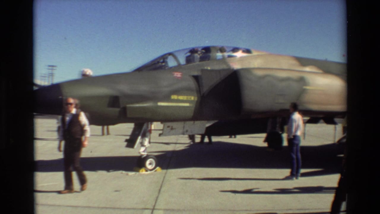 At Beale AFB in 1981, visitors stand beside a gray camouflaged F-4 Phantom II during an air show display.