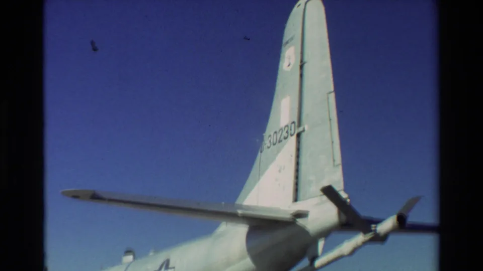 1981 Beale AFB 8mm exterior frame with aircraft tail number 0-30230, wing surface, propeller, and blue sky.