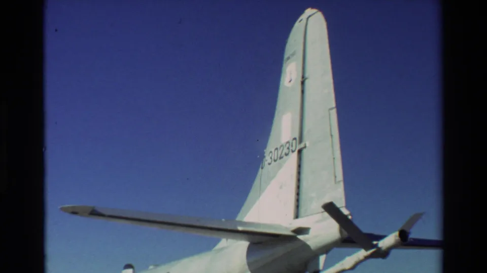 Exterior 8mm view of a U.S. military aircraft tail, wing, and propeller, supported by 1981 Beale AFB metadata.
