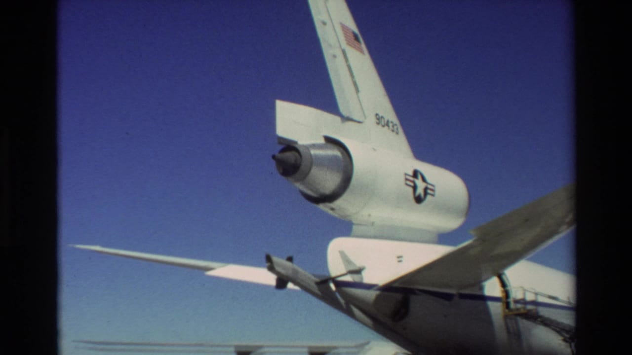 1981 Beale AFB 8mm frame showing the C-141 Starlifter tail section, rear-mounted engine, high wing, U.S. flag marking, and tail number.