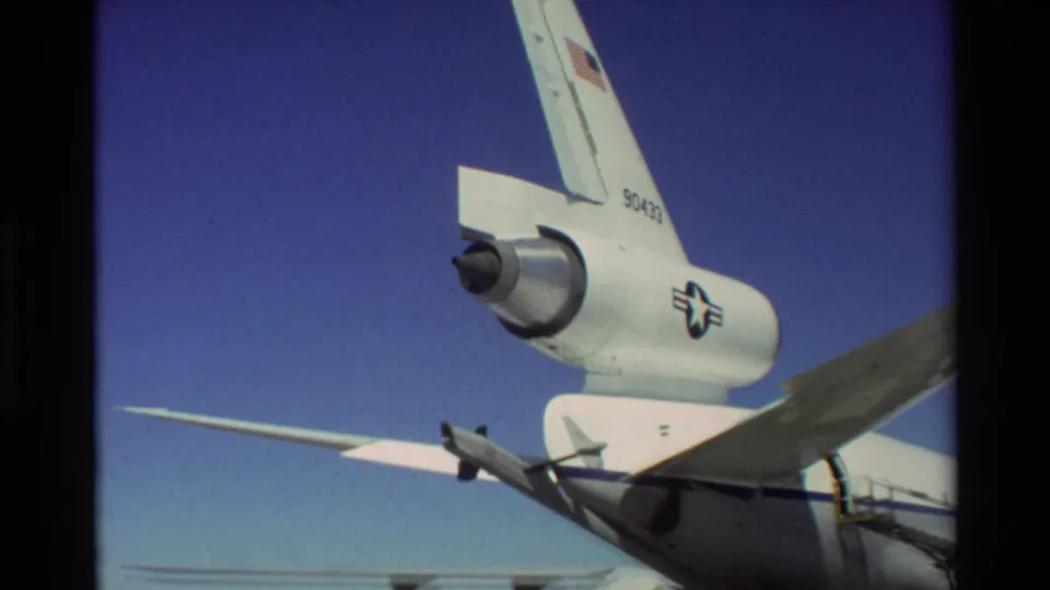1981 Beale AFB 8mm frame showing the C-141 Starlifter tail section, rear-mounted engine, high wing, U.S. flag marking, and tail number.