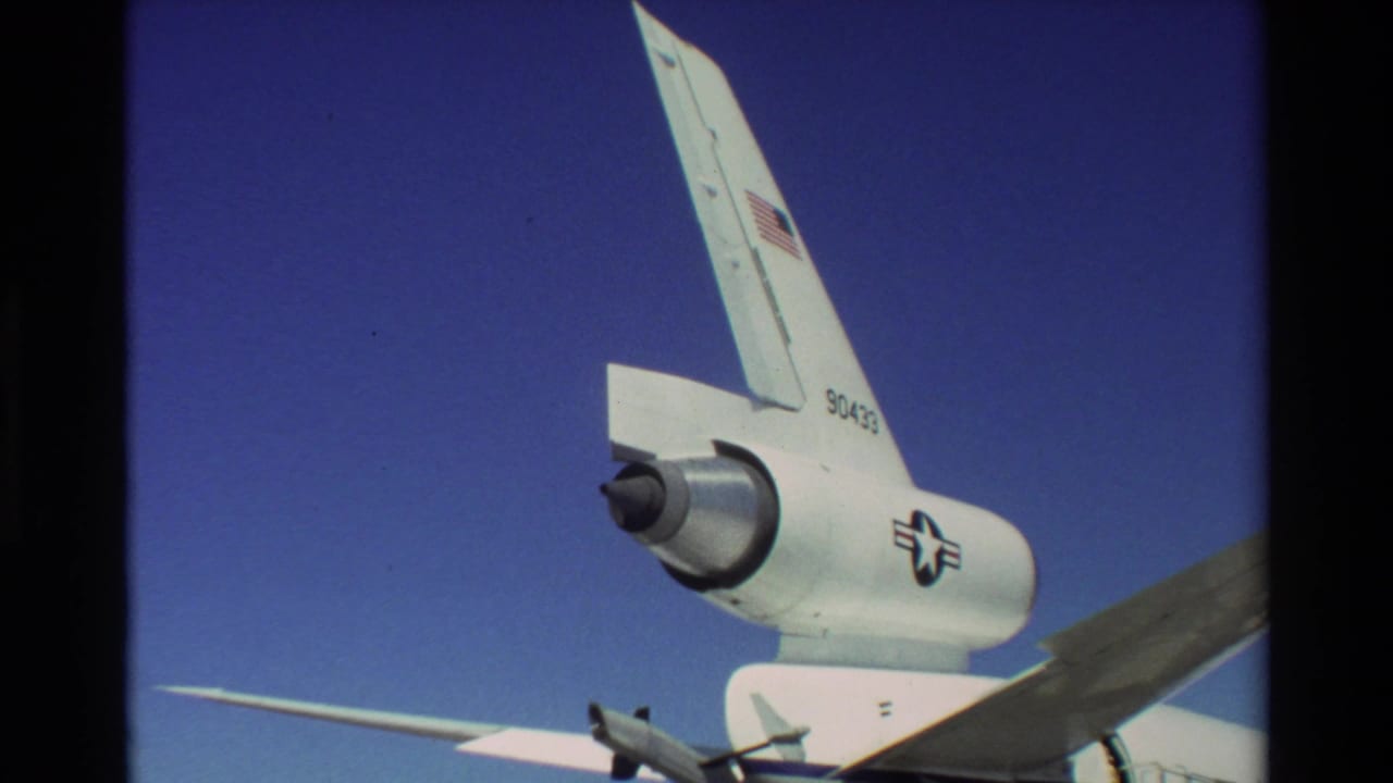 Close 8mm view of the C-141 Starlifter rear fuselage at Beale AFB, with T-tail, engine pod, military insignia, and tail number visible.