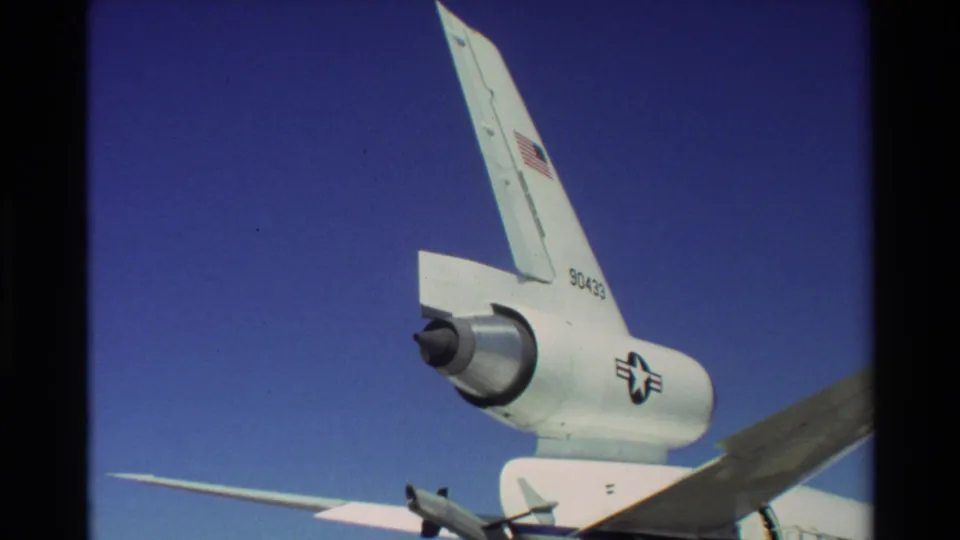 Close 8mm view of the C-141 Starlifter rear fuselage at Beale AFB, with T-tail, engine pod, military insignia, and tail number visible.