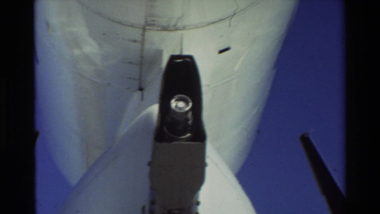 1981 Beale AFB 8mm frame showing the underside of a U.S. Air Force KC-135-type tanker and refueling boom hardware.