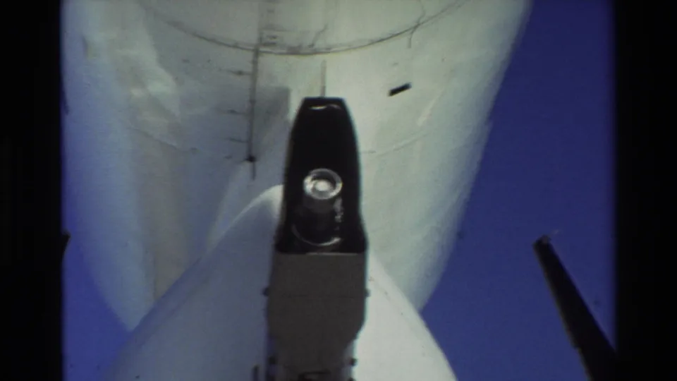 1981 Beale AFB 8mm frame showing the underside of a U.S. Air Force KC-135-type tanker and refueling boom hardware.