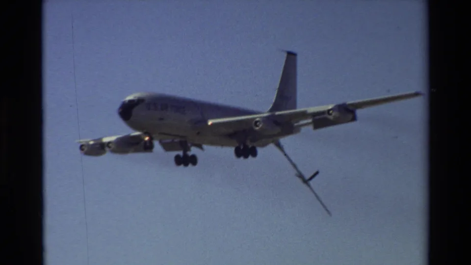 Closer 8mm frame of a U.S. Air Force tanker with landing gear down and refueling boom extended near Beale AFB in 1981.