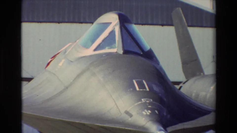Close view of a dark, sleek aircraft nose and cockpit canopy at Beale AFB, likely an SR-71-type aircraft display.