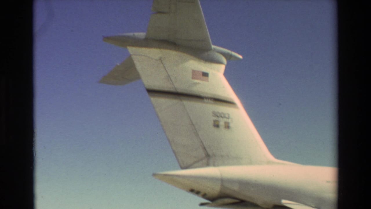 1981 Beale AFB footage showing the tail of a large white U.S. Air Force aircraft with flag and tail number markings.