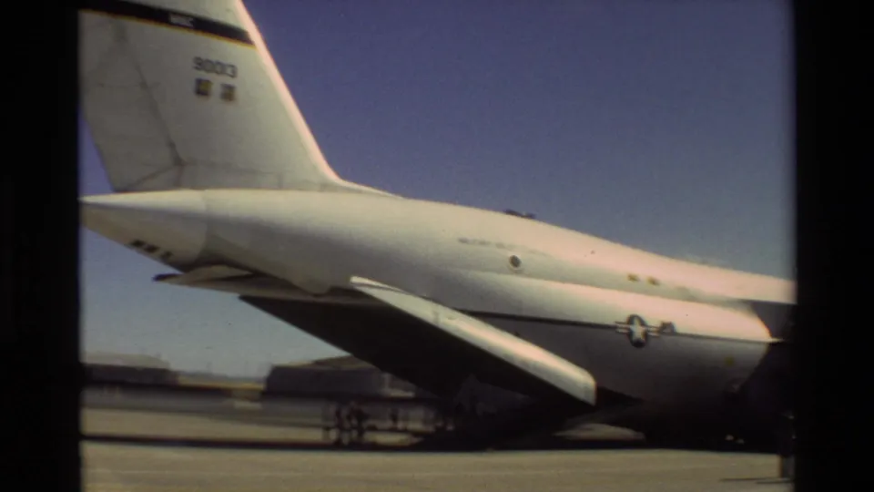 Large white U.S. Air Force aircraft parked at Beale AFB, with tail markings, wing, landing gear, and tarmac visible.