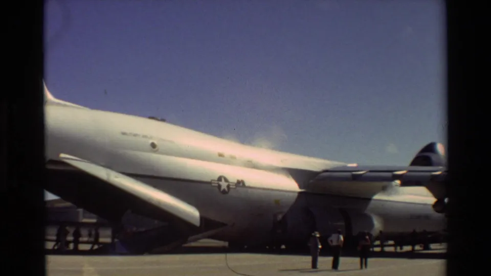 1981 Beale AFB view of a large U.S. Air Force aircraft with open cargo ramp and several people standing nearby.