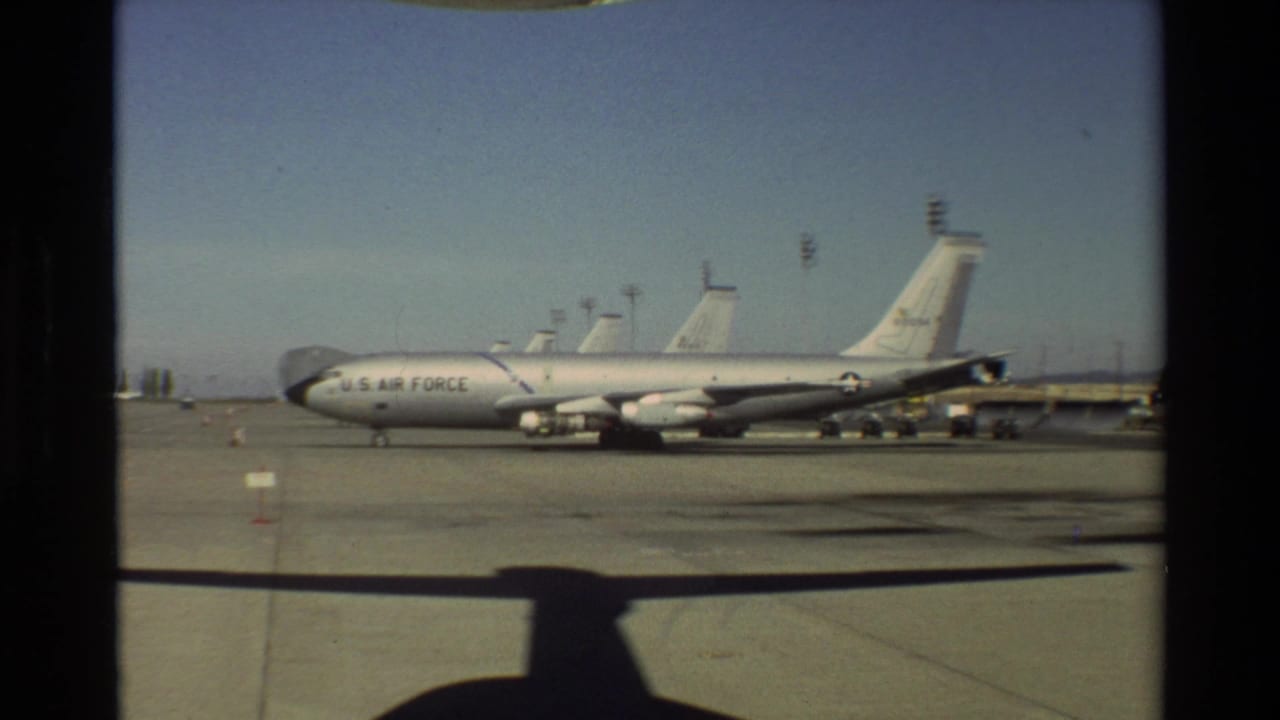 U.S. Air Force jet or transport aircraft parked on a wide tarmac under a clear sky.