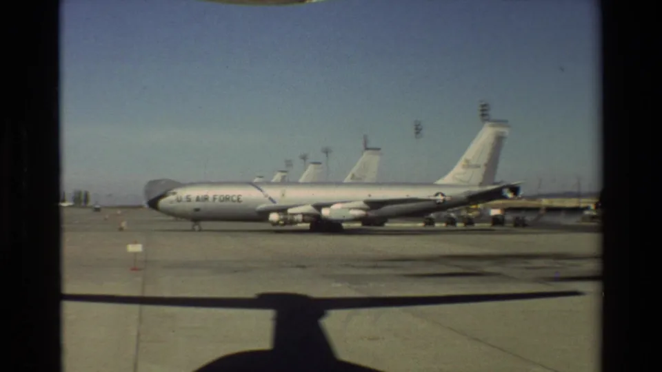 1981 Beale AFB tarmac view showing a marked U.S. Air Force aircraft parked in bright daylight, seen from inside another aircraft.