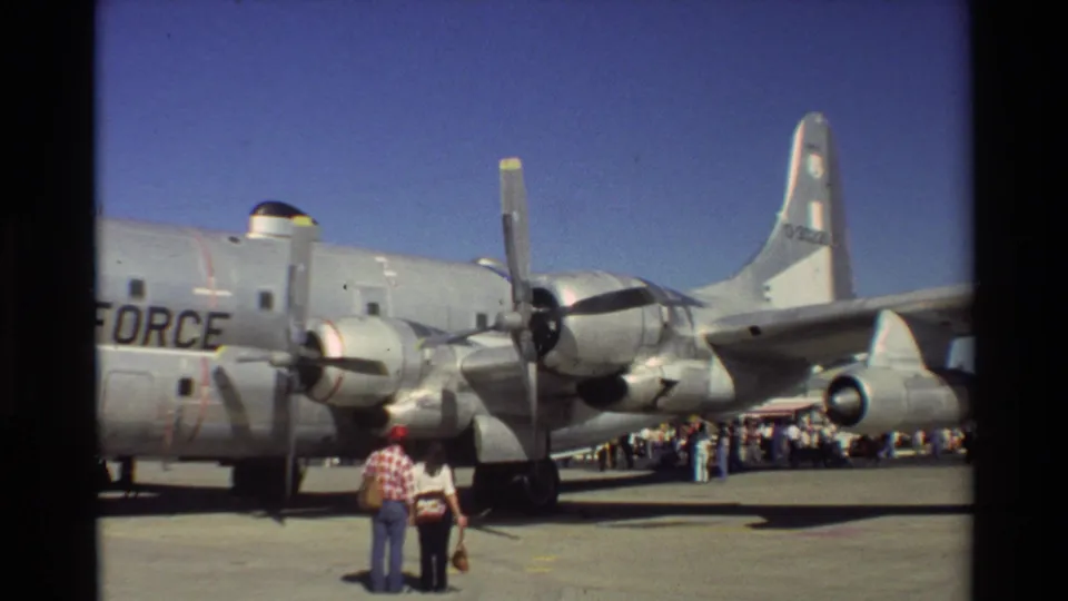 1981 Beale AFB side view of a large U.S. Air Force propeller aircraft on display, with visitors gathered along the tarmac.
