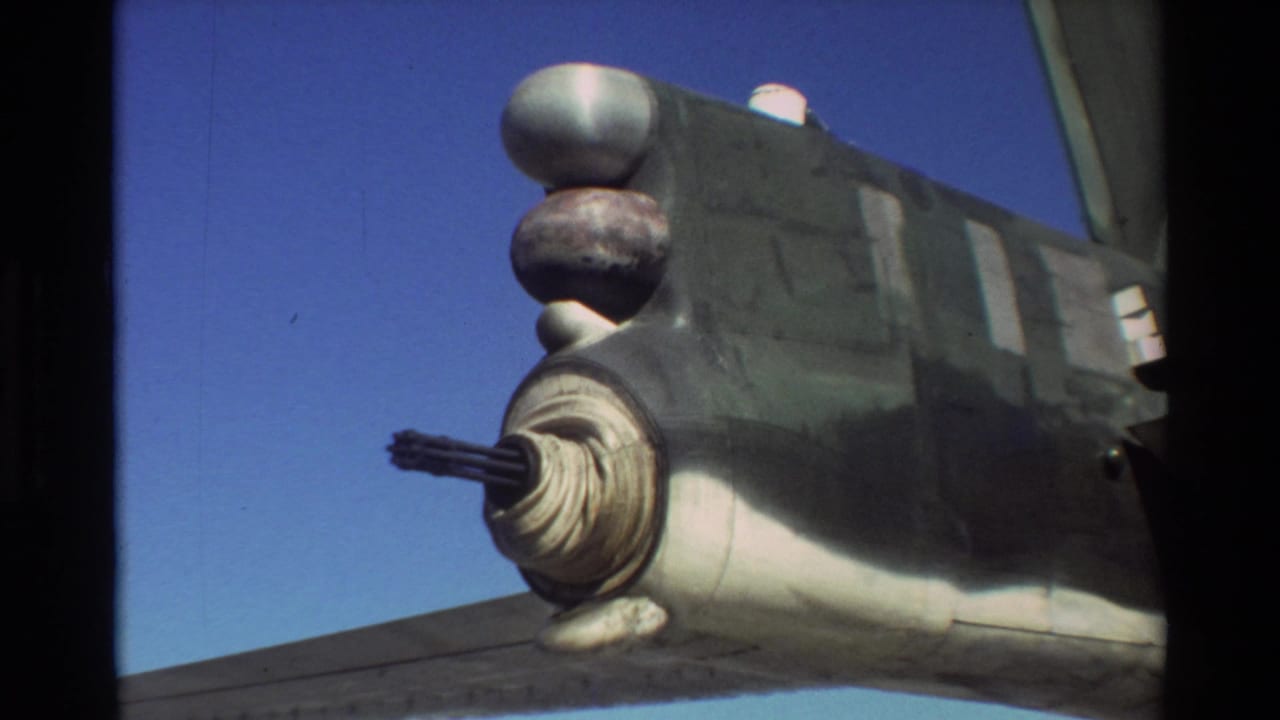 Close 8mm view of a military aircraft detail at Beale AFB, with a barrel-like assembly and rounded fittings visible against sky.