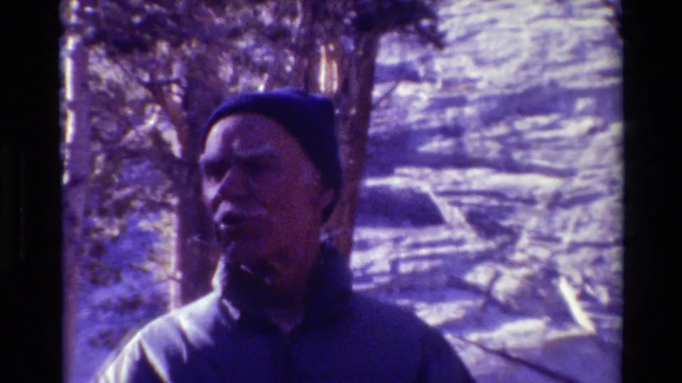 1981 British Columbia home-movie close-up of an older man in a knit cap, framed against snowy woods.