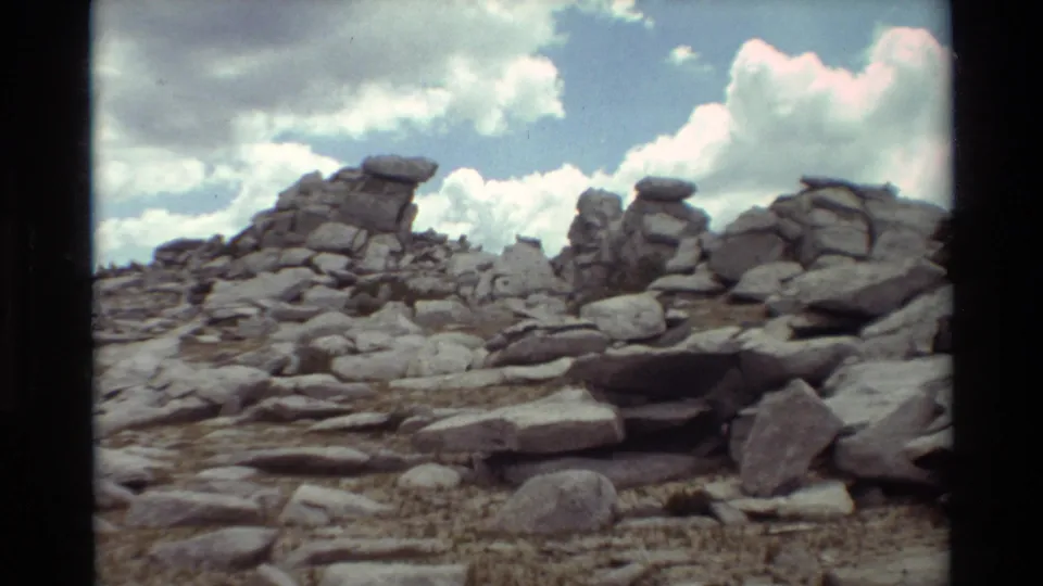 Close view of boulder-covered terrain and layered stone in a 1981 8mm outdoor travel scene.