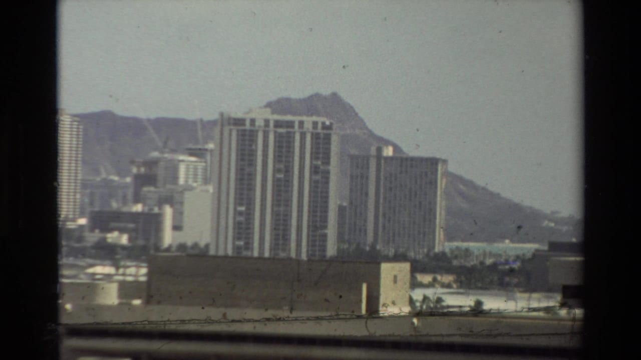 1981 Hawaii home-movie view of shoreline high-rises with Diamond Head visible behind them.