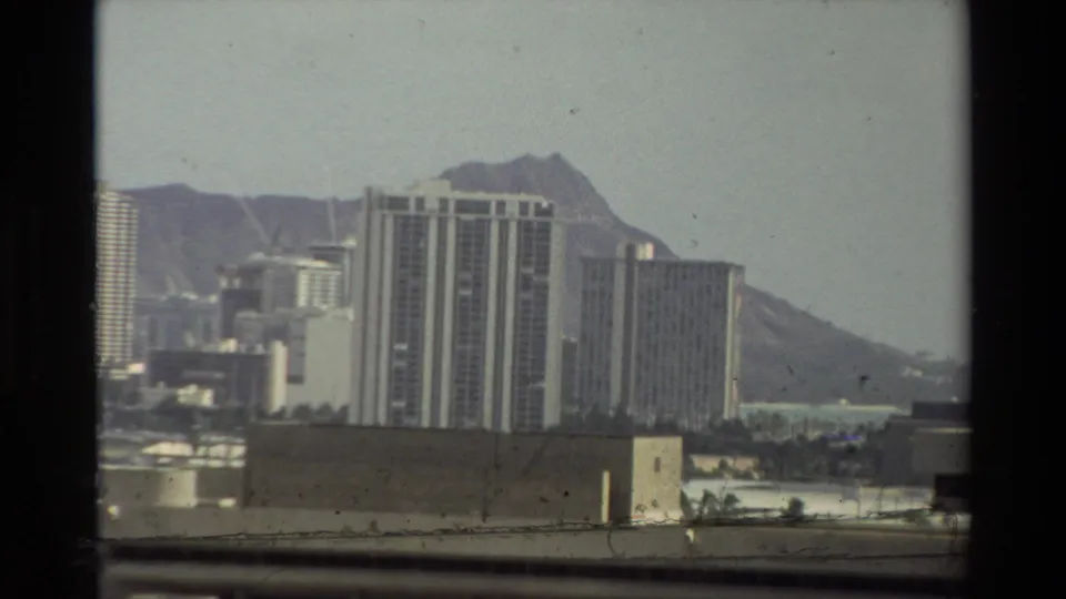 1981 Hawaii home-movie view of shoreline high-rises with Diamond Head visible behind them.