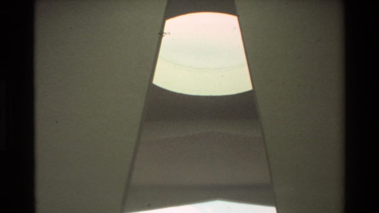 1981 Hawaii 8mm view looking upward through the USS Arizona Memorial interior toward a bright skylight-like opening.