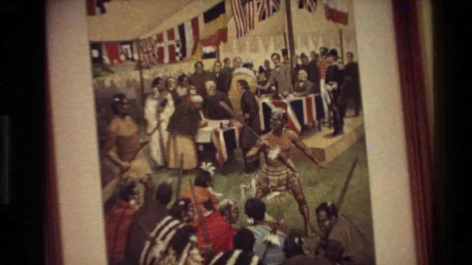 1981 New Zealand home-movie frame showing a framed historical painting of a colonial-era gathering with Māori and European figures.