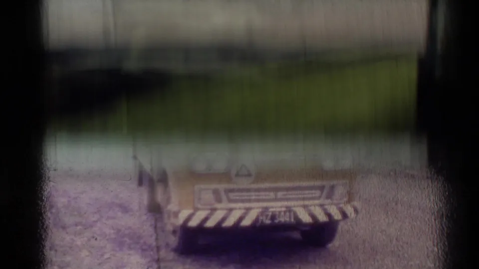 Yellow utility van appears partially obscured in a soft 1981 New Zealand home-movie frame.